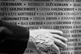 Visitor's hand pointing to a family member's name